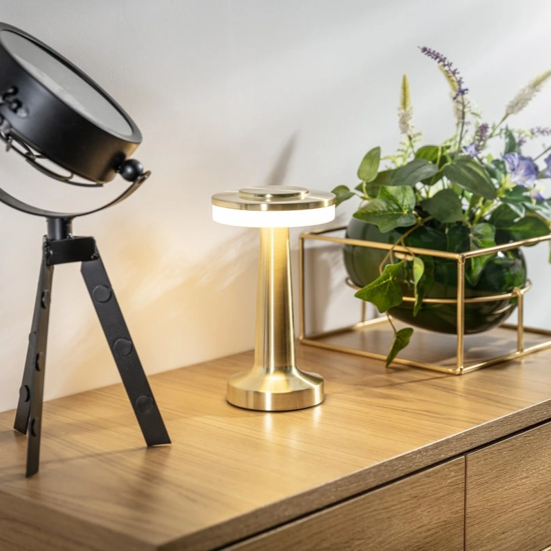 "Wireless retro table lamp with luxurious metallic finish, dimmable LED light, versatile cordless design for any setting."