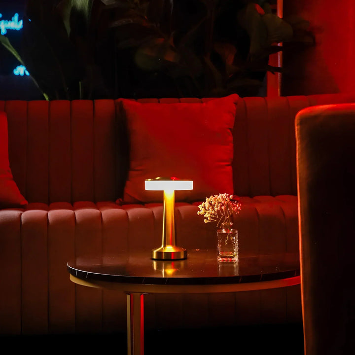 "Wireless retro table lamp with luxurious metallic finish, dimmable LED light, versatile cordless design for any setting."