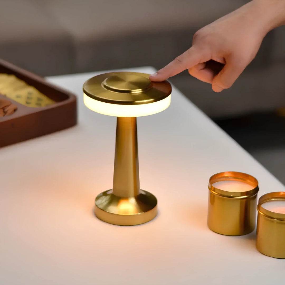 "Wireless retro table lamp with luxurious metallic finish, dimmable LED light, versatile cordless design for any setting."
