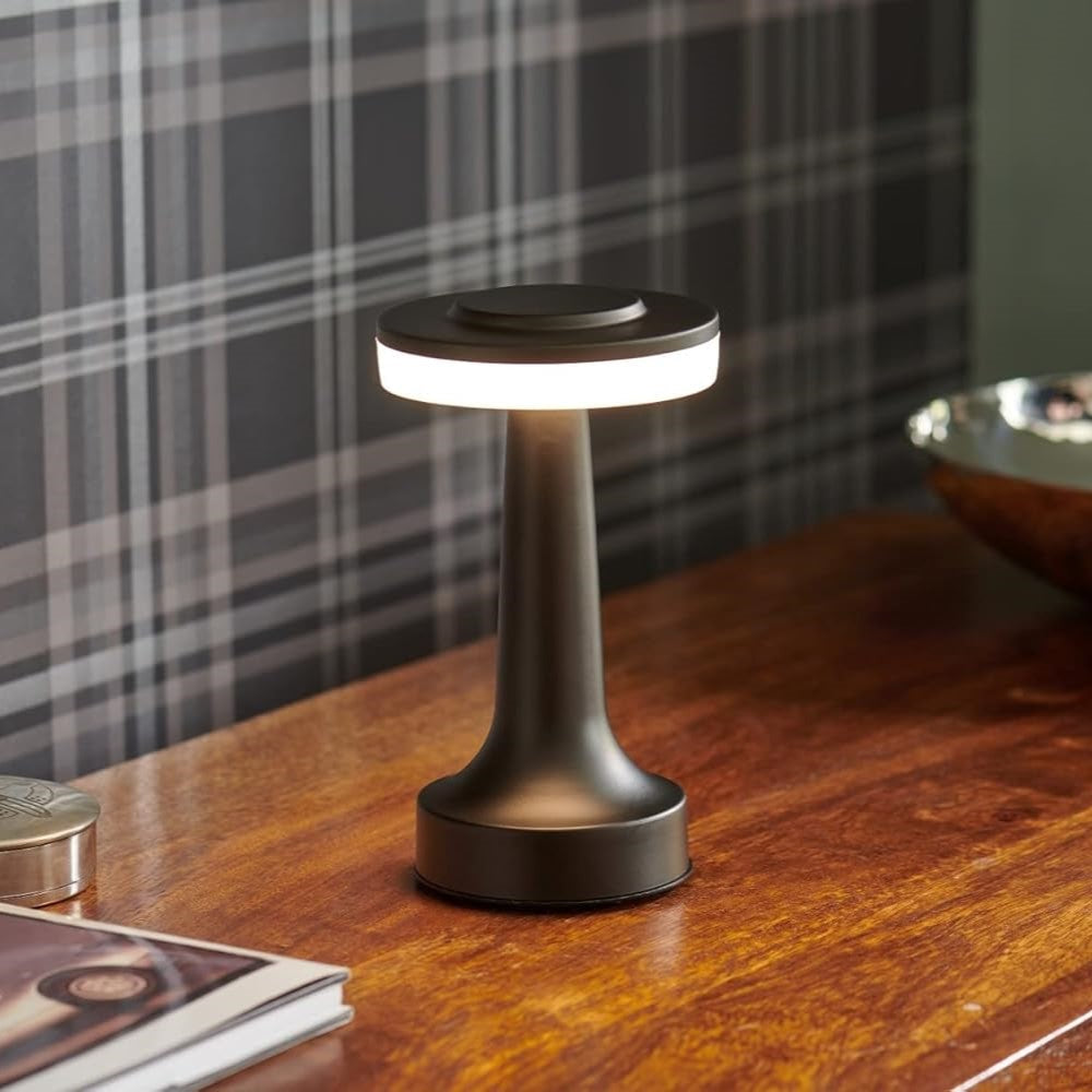"Wireless retro table lamp with luxurious metallic finish, dimmable LED light, versatile cordless design for any setting."