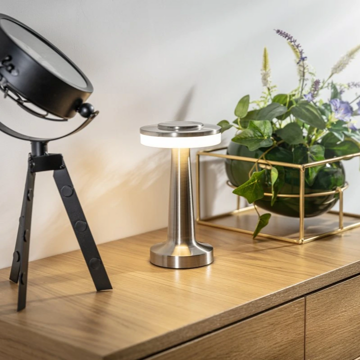 "Wireless retro table lamp with luxurious metallic finish, dimmable LED light, versatile cordless design for any setting."
