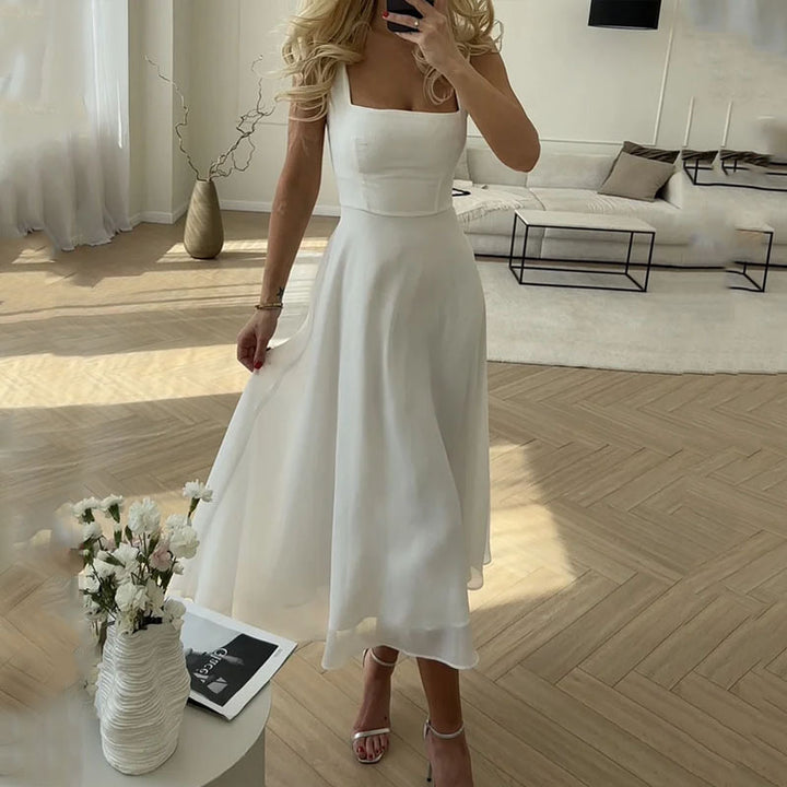 "Woman in elegant black sleeveless square neck A-line midi dress"
