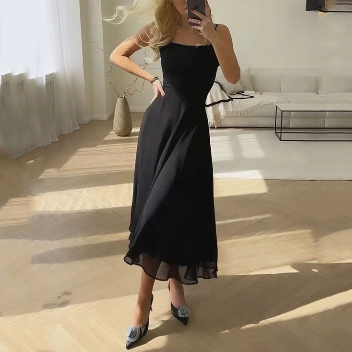 "Woman in elegant black sleeveless square neck A-line midi dress"