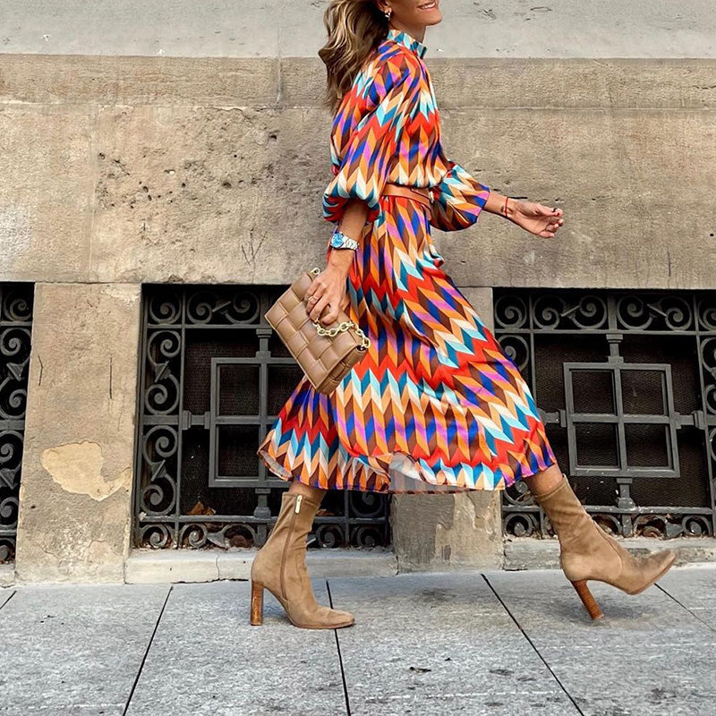 Woman wearing a vibrant, artistic print midi dress, flattering fit, breathable, perfect for sunny days and casual outings.