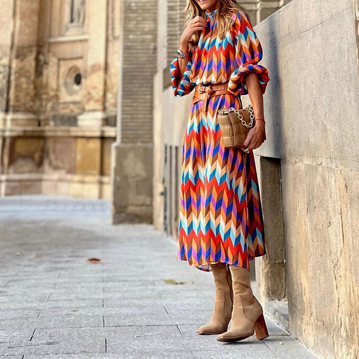 Woman wearing a vibrant, artistic print midi dress, flattering fit, breathable, perfect for sunny days and casual outings.