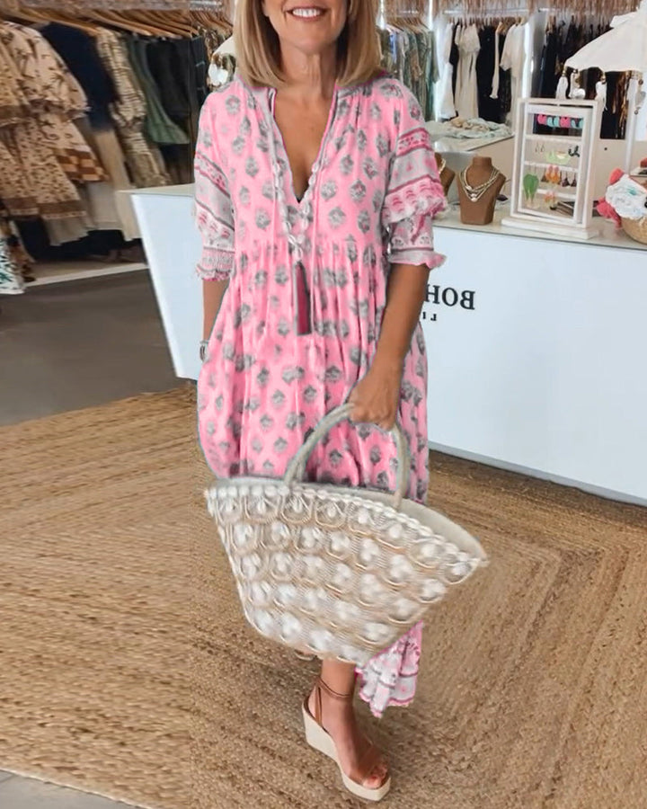 Women's V-Neck Half-Sleeve Dress with bold print, vibrant colors; casual or evening wear, enhances elegance and comfort.