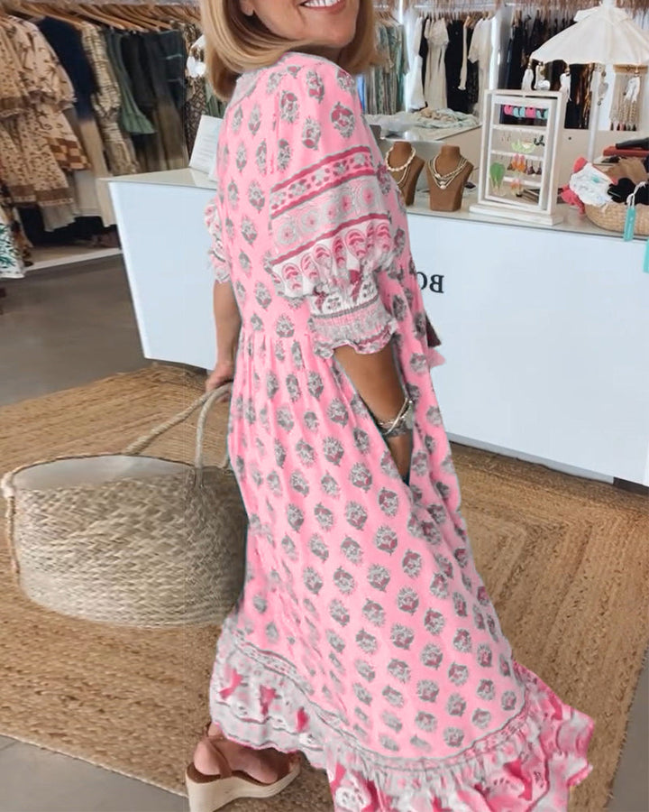 Women's V-Neck Half-Sleeve Dress with bold print, vibrant colors; casual or evening wear, enhances elegance and comfort.
