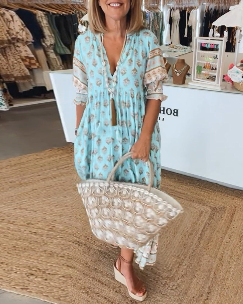 Women's V-Neck Half-Sleeve Dress with bold print, vibrant colors; casual or evening wear, enhances elegance and comfort.