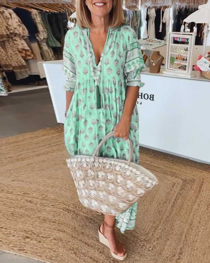 Women's V-Neck Half-Sleeve Dress with bold print, vibrant colors; casual or evening wear, enhances elegance and comfort.