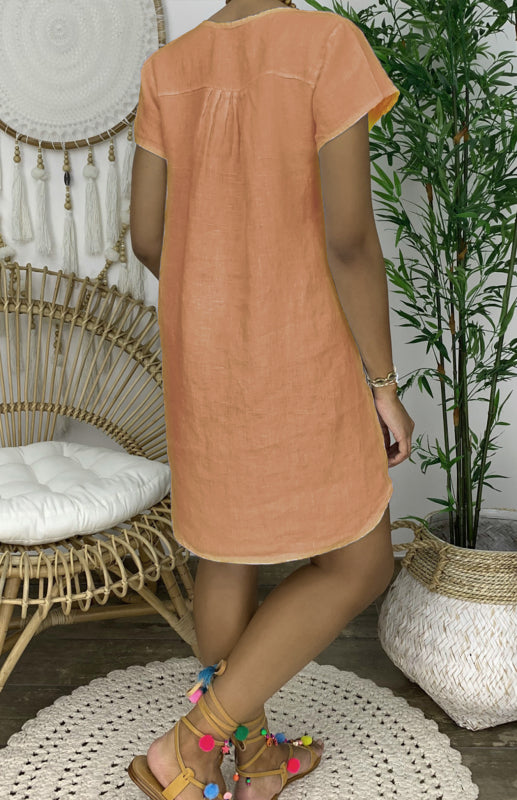 "Women's V-neck linen dress with curved hem and rolled sleeves, shown from the front in light, breathable fabric."