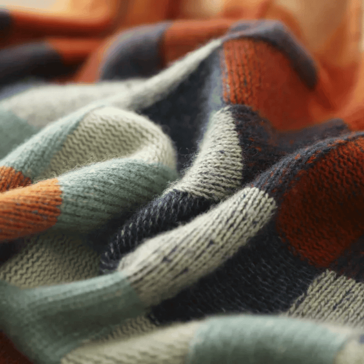 Women's cashmere patchwork turtleneck sweater in mélange hues, showcasing a unique, cozy, and stylish design for winter.