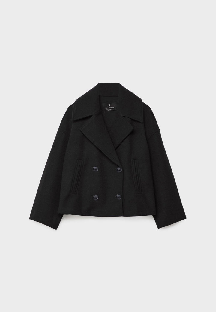 Women's double-breasted cropped jacket, front view featuring sharp lapels, structured design, and chic oversized buttons.