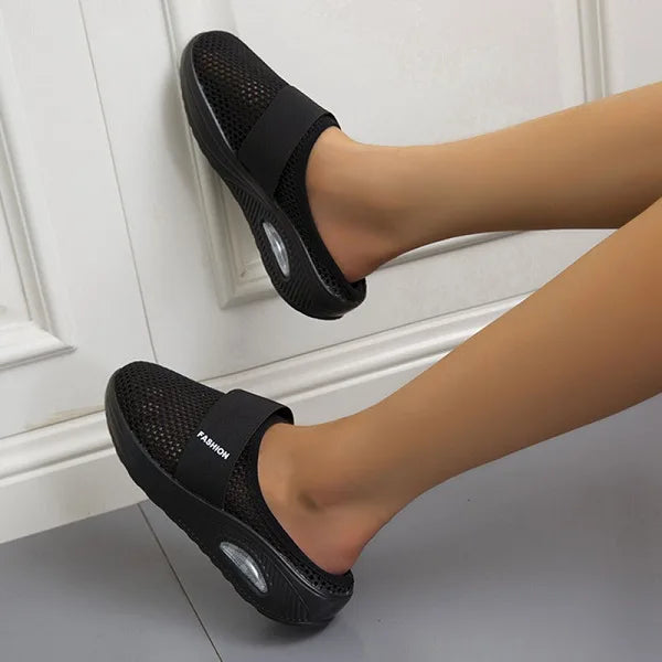Women's orthopedic breathable slippers in black, showcasing ergonomic cushioning and a slip-on design.