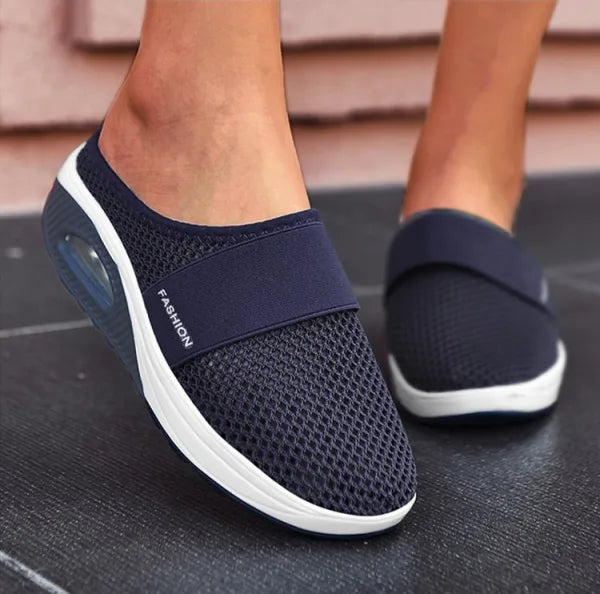A pair of women's orthopedic breathable slippers in red, emphasizing comfort and style.