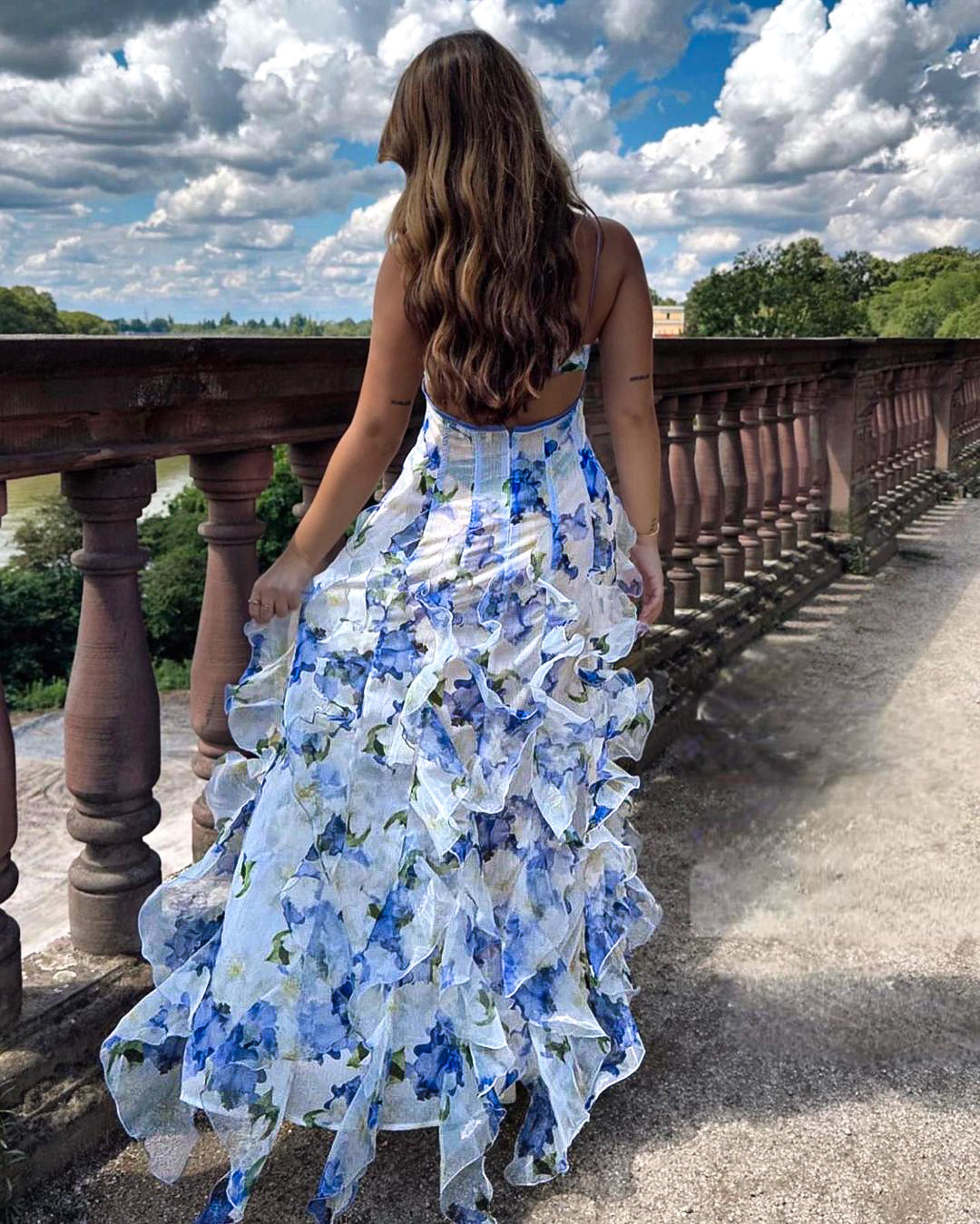 "Women's ruffled floral dress, flowy silhouette, front view, vibrant flowers, elegant and sophisticated attire."