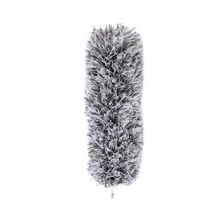Corner cleaning with an extendable pole duster; the flexible head reaches awkward angles.
