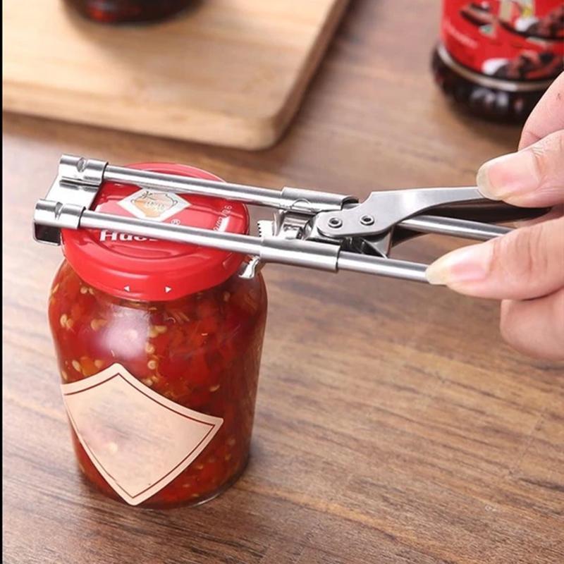 Ergonomic kitchen adjustable jar opener made of stainless steel, demonstrating use on a glass jar lid.