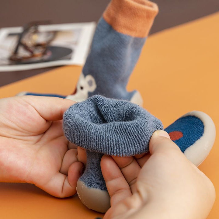 Soft-soled infant sock shoes with a charming cartoon pattern for cozy feet