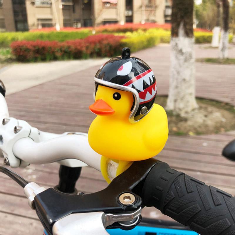 Bright yellow duck bike bell, a quirky bicycle accessory with an LED light, for kids & safety