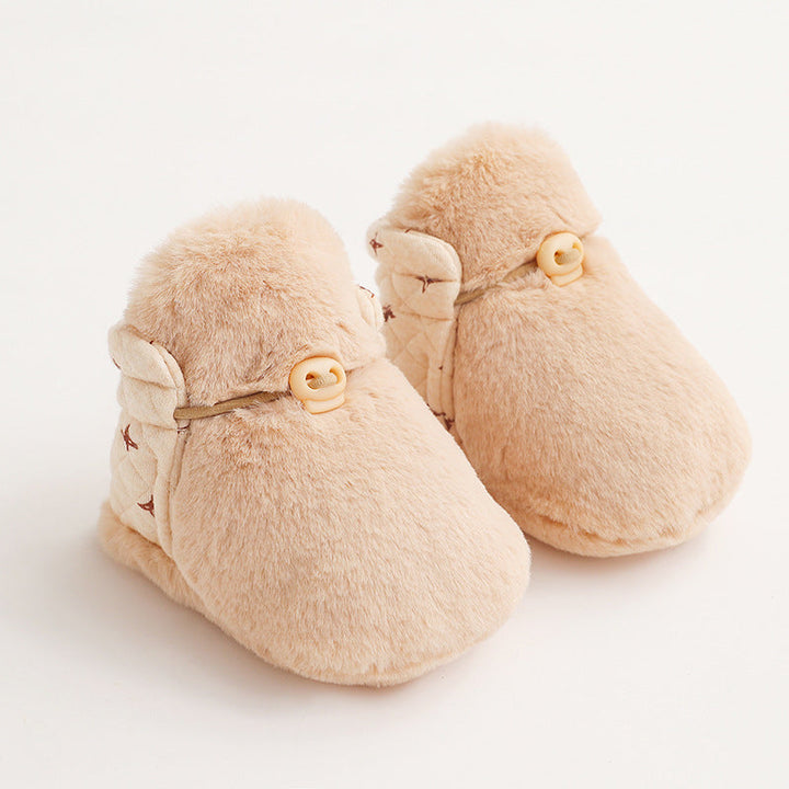 Bottom of a cartoon plush cotton baby shoe showing the anti-slip grip for toddlers