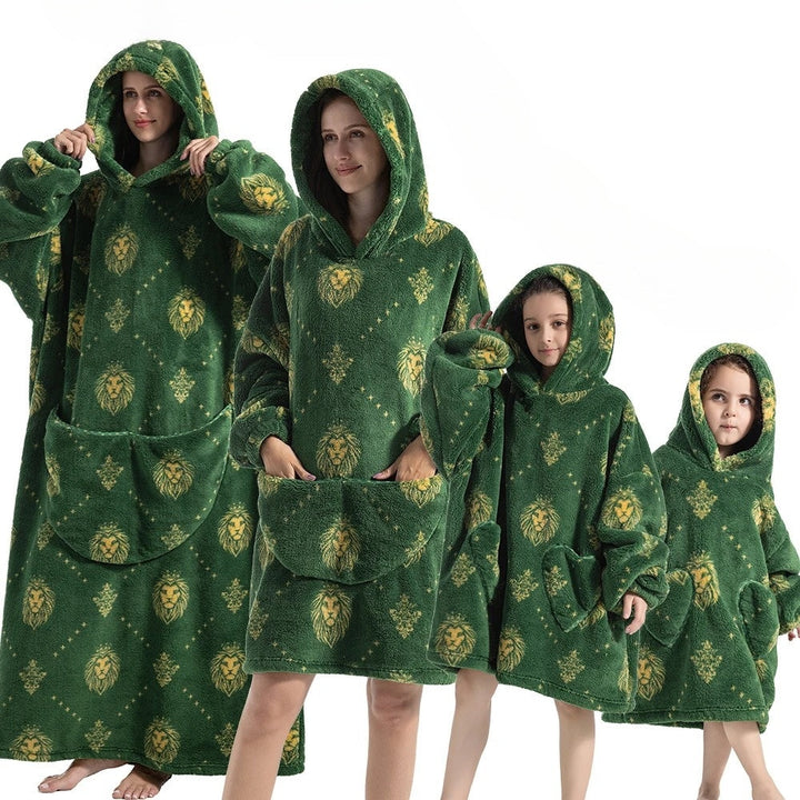 Vibrant pumpkin design hoodie blanket, providing cozy warmth for spooky season & autumn evenings.
