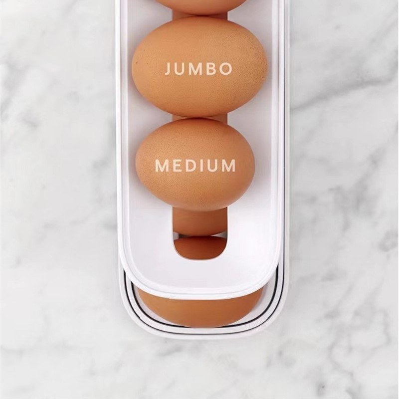 Automatic egg dispenser filled with eggs, ready for use. Smart refrigerator organizer for fresh eggs.