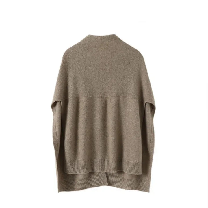 Elegant women's soft knitted cape in beige, ideal for layering and stylish autumn-winter outfits.