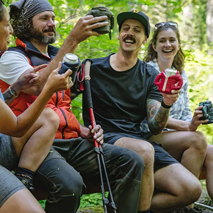 Person enjoying a cold drink in a can sleeve, keeping beverage chilled, practical accessory
