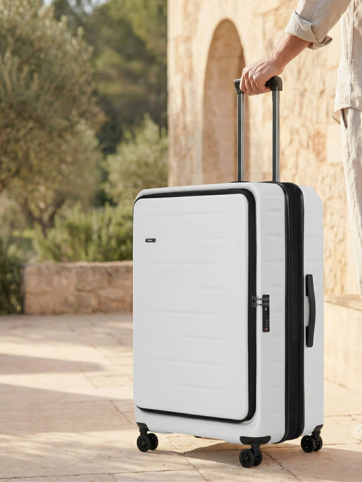 Durable silver hardshell carry-on luggage, expandable, with front pocket & TSA lock for secure travel.