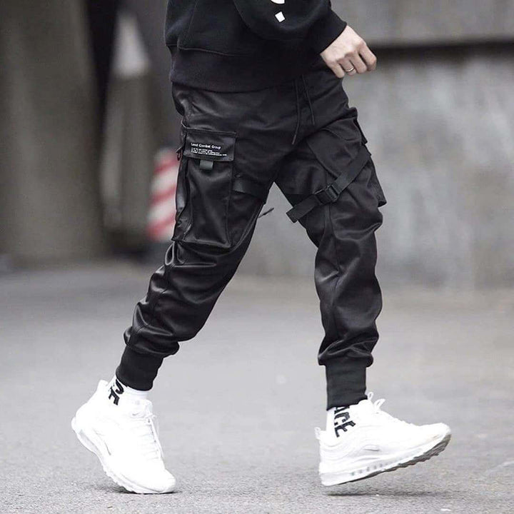 Men's black streetwear cargo pants, multi-pocket design. Hip-hop inspired, comfortable & versatile.