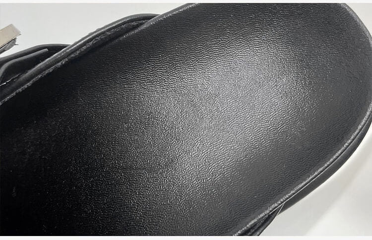 Detail of the high platform sole on women's black studded sandals, perfect for bold fashion.
