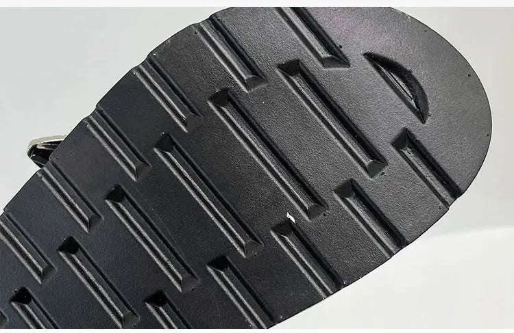 Front view of women's black platform sandals, featuring eye-catching stud embellishments.