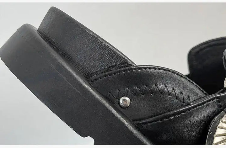 Three-quarter view of women's stylish black studded platform sandals, a bold fashion choice.