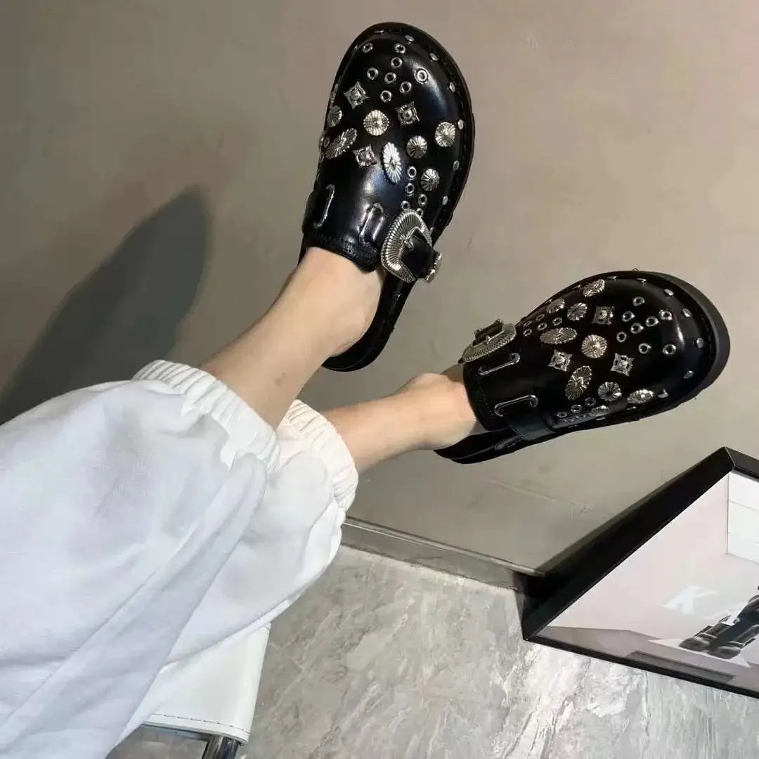 Top-down view of women's fashion-forward black platform sandals, adorned with stylish stud accents.