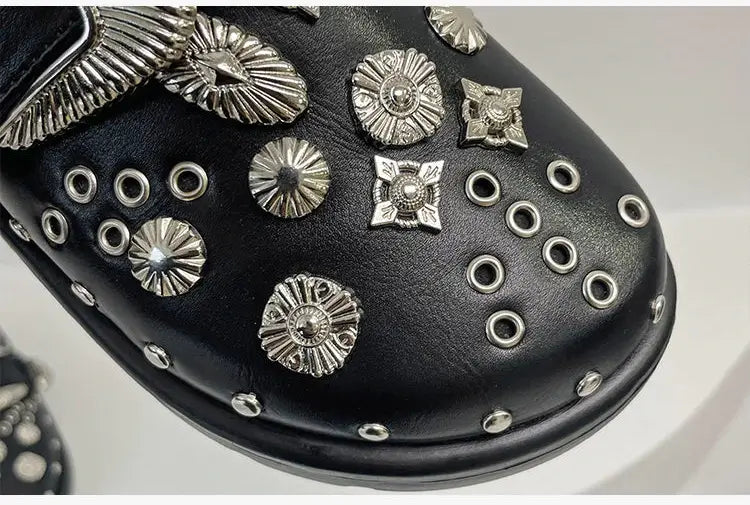 Close-up of the studded straps on women's edgy black platform sandals, showcasing detail.