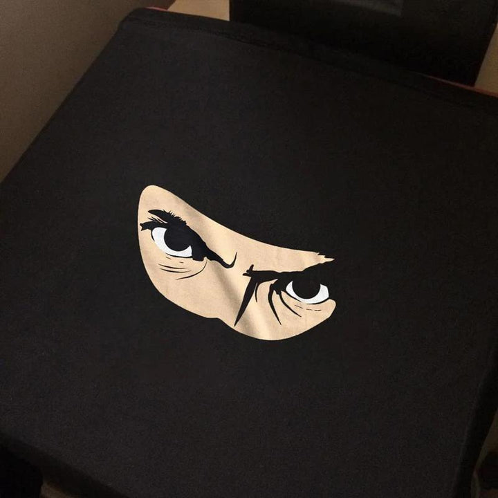 Black cotton t-shirt with a unique flip-up ninja design, a fun graphic tee for unisex wear.