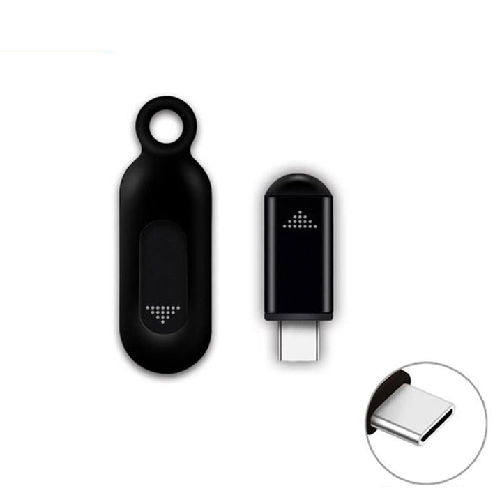 Silver infrared remote control connected to a smartphone, showcasing its minimalist and elegant design