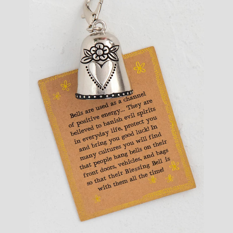 Close-up of a Blessing Bell Charm, highlighting a delicate heart design, symbolizing luck