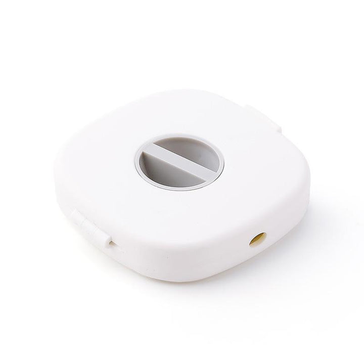 Universal cable winder & phone stand in white from an aerial view, emphasizing its multi-functional design.
