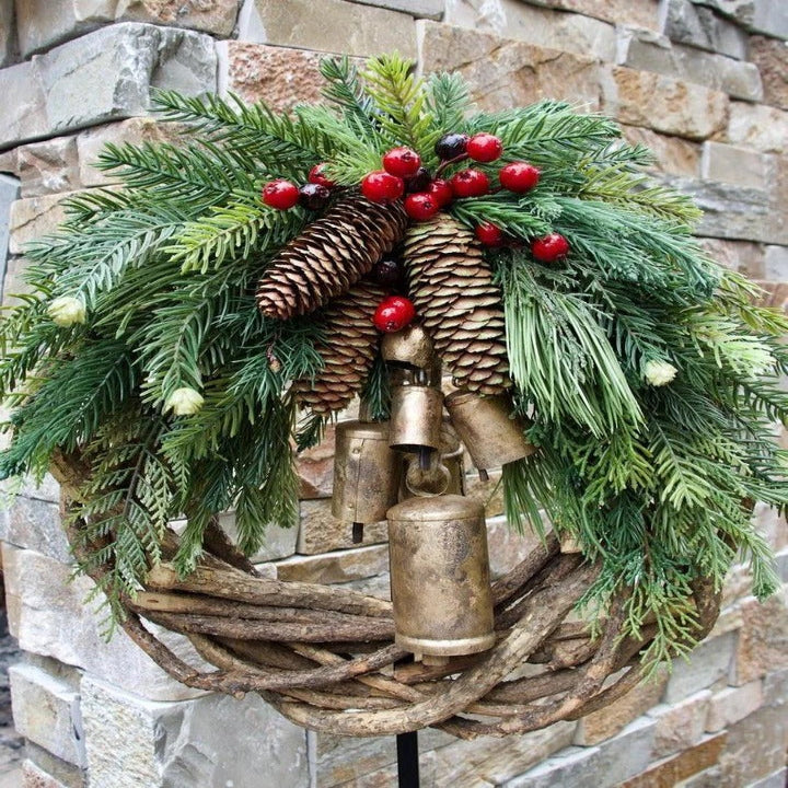 Festive bohemian Christmas wreath for front door or indoor decor. Features natural vine, pinecones, and berries.