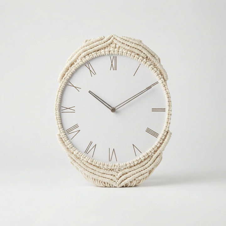 Close-up of a bohemian wall clock, showcasing detailed macrame work and the analog clock face.