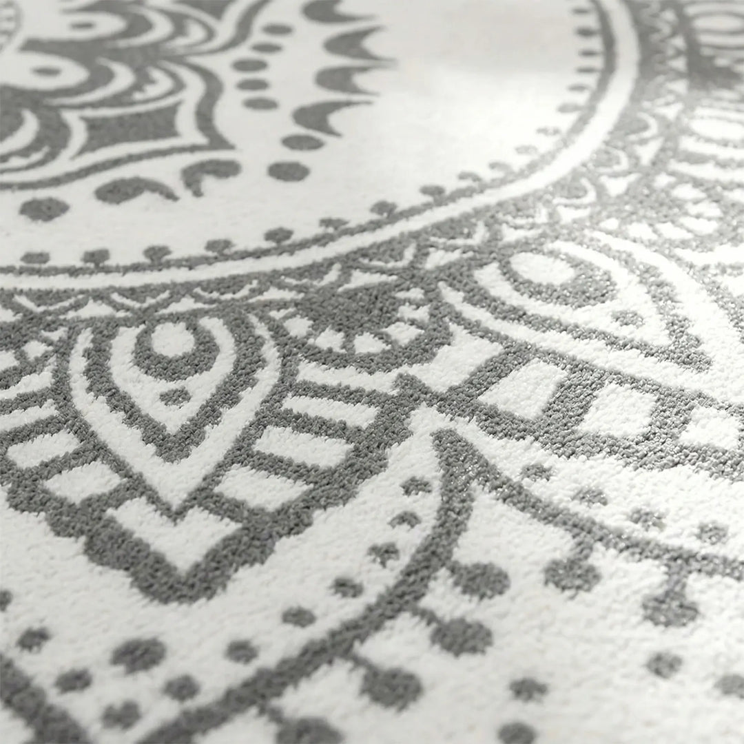Decorative round bohemian accent rug with an elegant Flowique pattern, enhancing home decor.