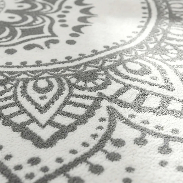 Decorative round bohemian accent rug with an elegant Flowique pattern, enhancing home decor.