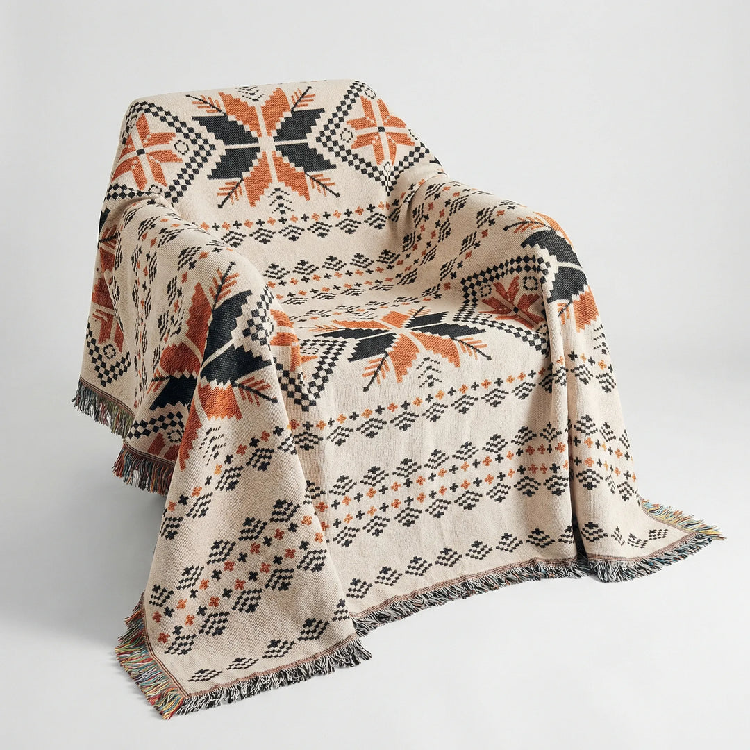 Vibrant geometric woven throw blanket with fringe detail. Boho southwestern style accent rug for cozy home decor.