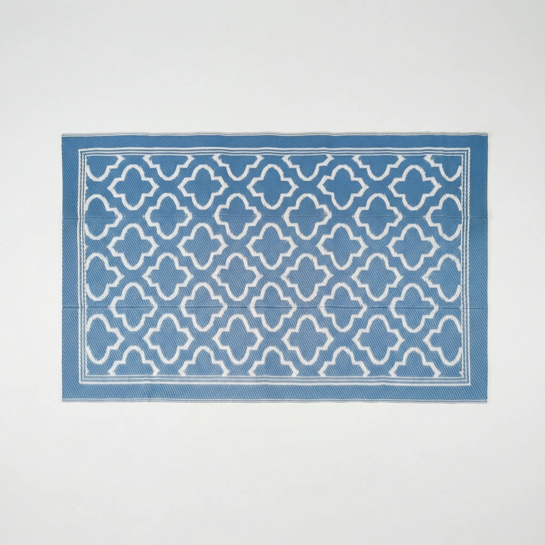 Flowique statement outdoor area rug featuring a modern geometric wave design. Non-slip and durable for decks.