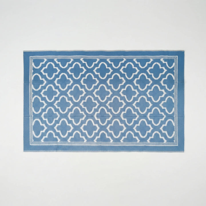 Flowique statement outdoor area rug featuring a modern geometric wave design. Non-slip and durable for decks.