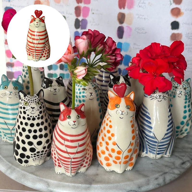 Charming ceramic cat vase with bold polka dots, perfect for showcasing blossoms and enhancing table decor