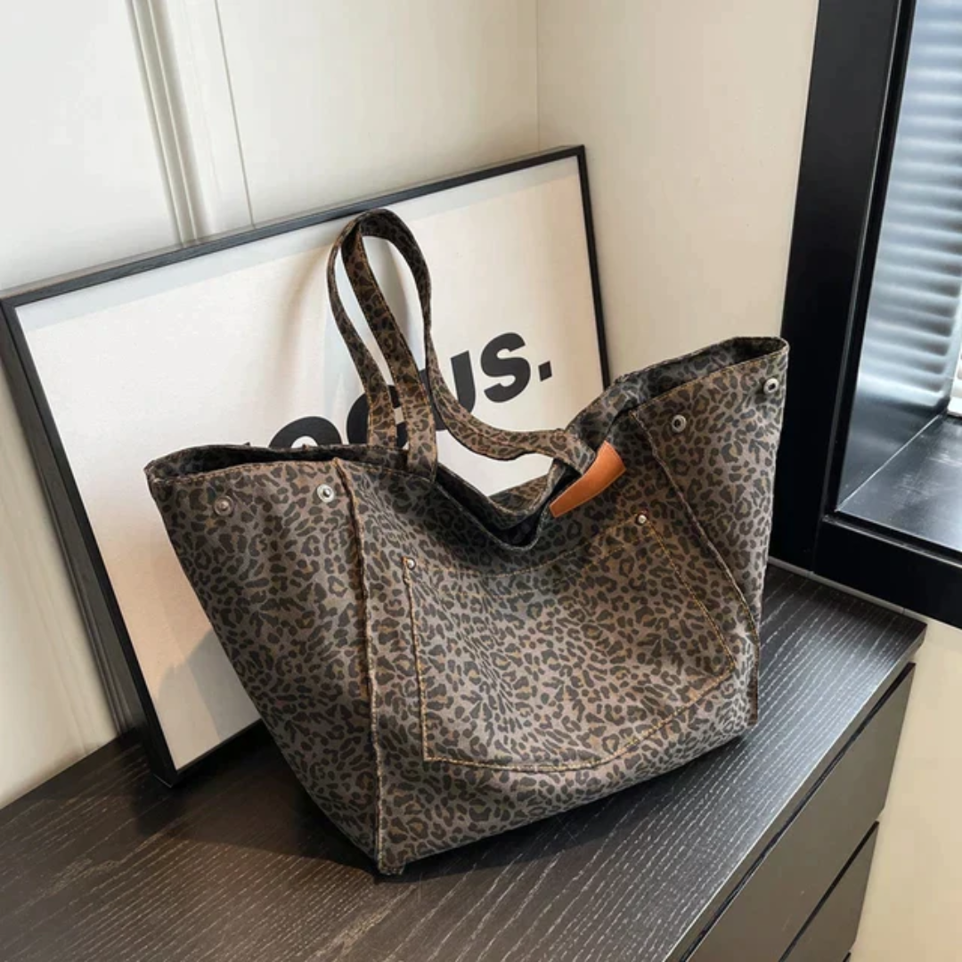 Women's stylish black & brown leopard print handbag. A chic fashion accessory shoulder bag for daily use.
