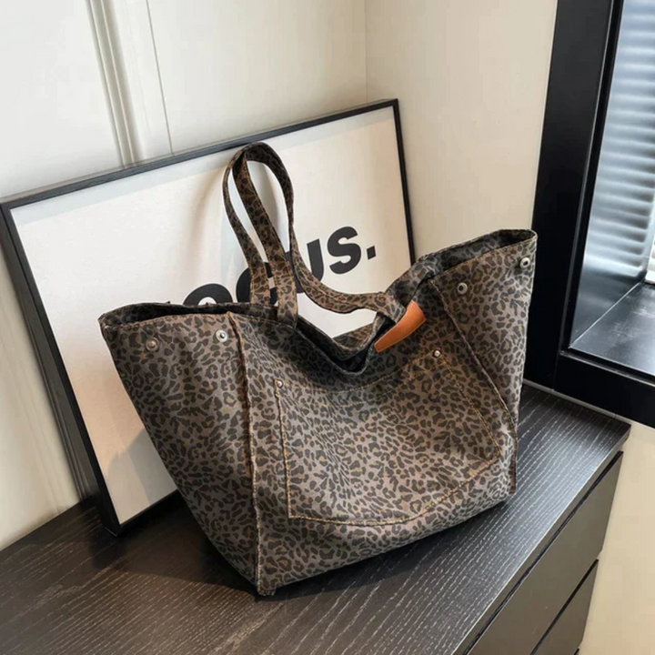 Women's stylish black & brown leopard print handbag. A chic fashion accessory shoulder bag for daily use.
