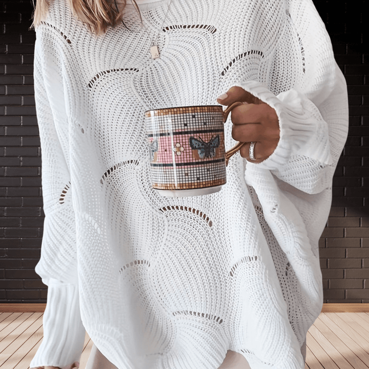 Chic women's autumn ribbed knit jumper with an asymmetric hem. Cozy, long-sleeve sweater for fall fashion.